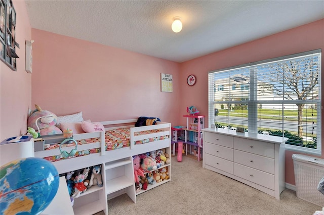 bedroom featuring light carpet and a textured ceiling