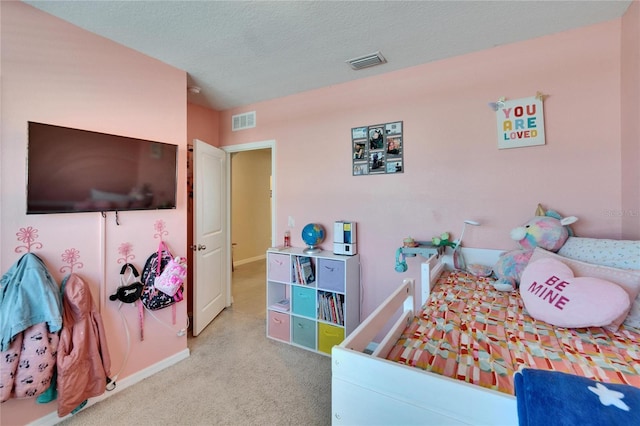 bedroom with carpet floors, visible vents, a textured ceiling, and baseboards