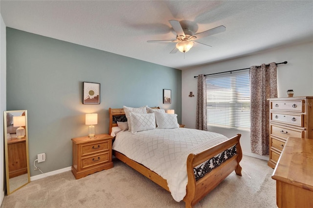 bedroom with light carpet, baseboards, and a ceiling fan