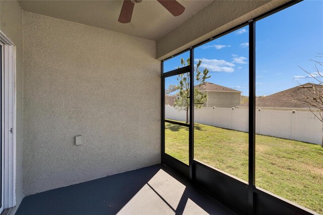 unfurnished sunroom featuring a healthy amount of sunlight and a ceiling fan