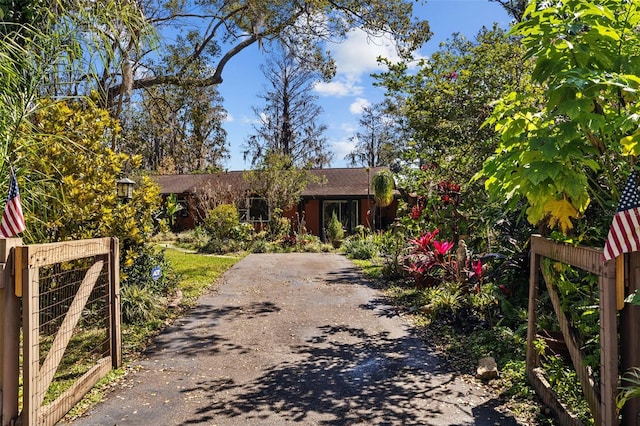 view of front of property with fence and a gate