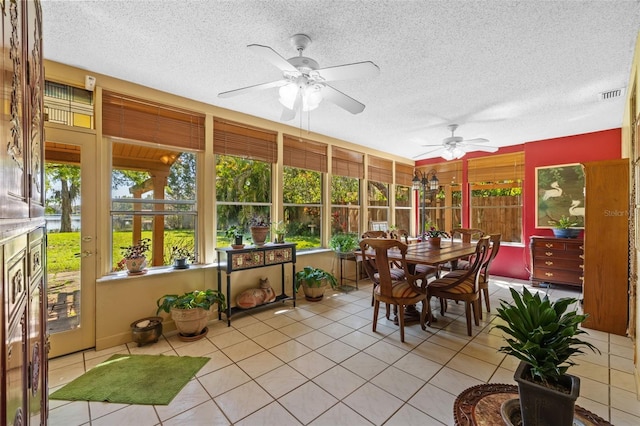 sunroom / solarium featuring ceiling fan and visible vents