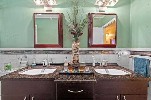 bathroom with a sink and double vanity