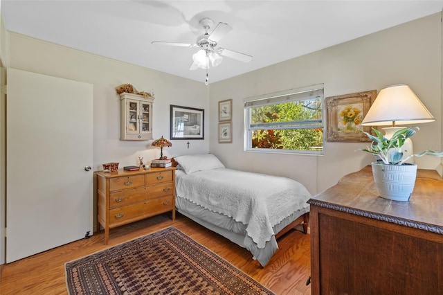 bedroom with a ceiling fan and wood finished floors