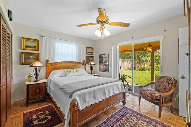 bedroom featuring access to exterior, a ceiling fan, and a closet