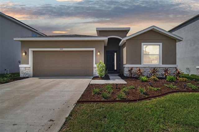 view of front of house with stone siding, an attached garage, stucco siding, and concrete driveway