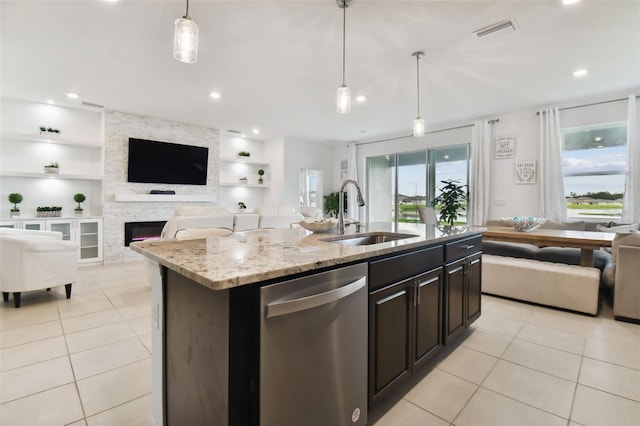 kitchen with a sink, visible vents, stainless steel dishwasher, and light tile patterned flooring