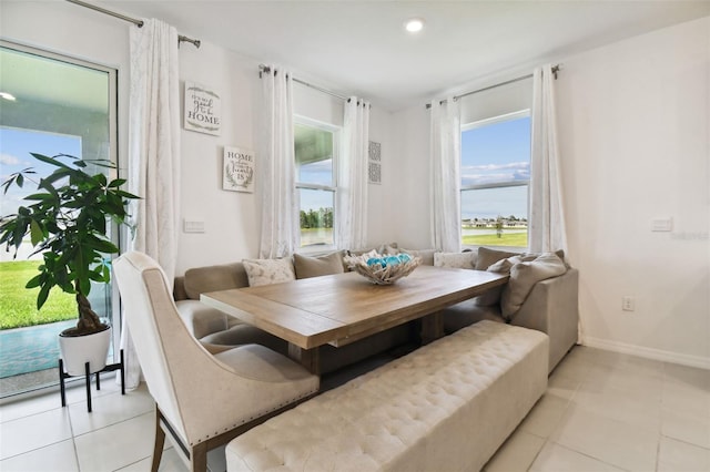 dining space with breakfast area, recessed lighting, tile patterned flooring, and baseboards