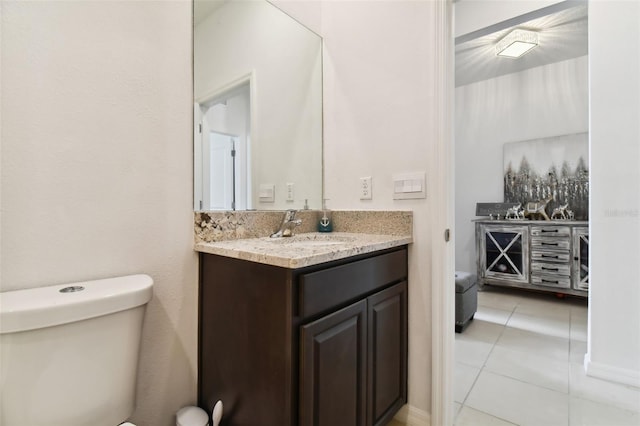 bathroom featuring toilet, vanity, and tile patterned floors