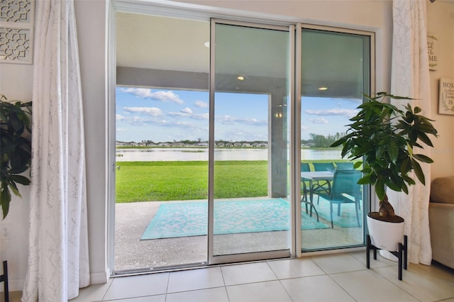 entryway featuring a water view and tile patterned floors