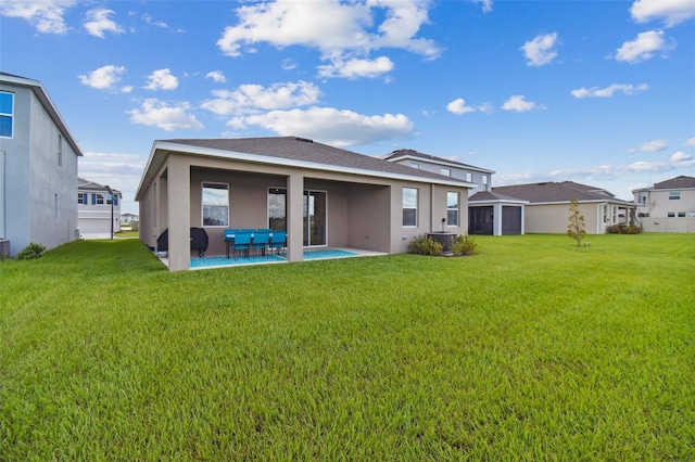 back of property with roof with shingles, a patio area, a yard, and stucco siding