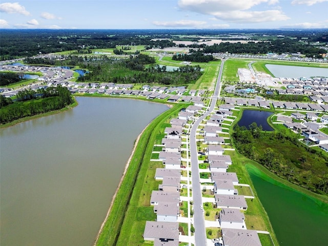 birds eye view of property with a water view and a residential view