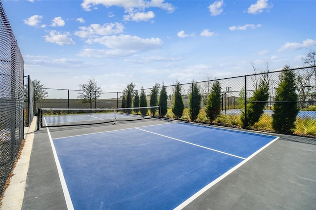 view of sport court featuring fence