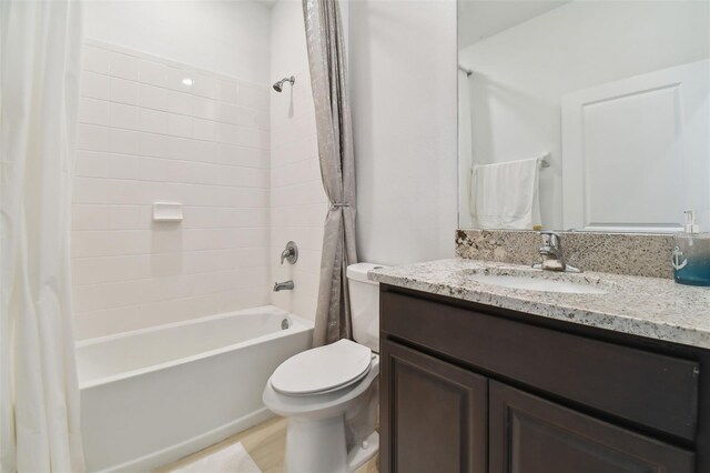 bathroom with toilet, vanity, and shower / bathtub combination with curtain