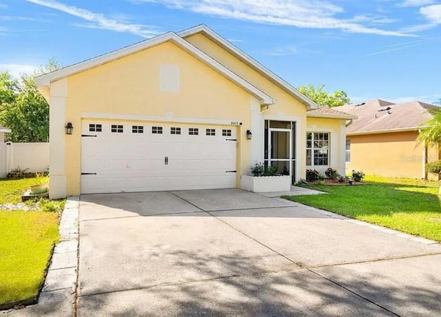 view of front of property with a garage, concrete driveway, a front yard, and stucco siding