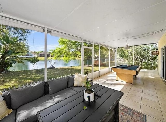 sunroom / solarium with a water view and billiards