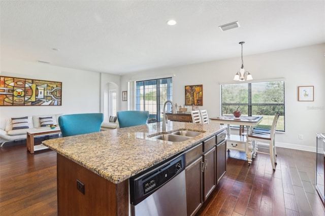 kitchen featuring arched walkways, dark wood-style flooring, a sink, visible vents, and stainless steel dishwasher