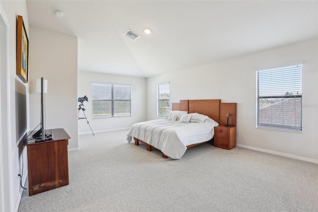 carpeted bedroom with visible vents, vaulted ceiling, and baseboards