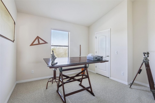 office area featuring carpet floors, baseboards, and lofted ceiling