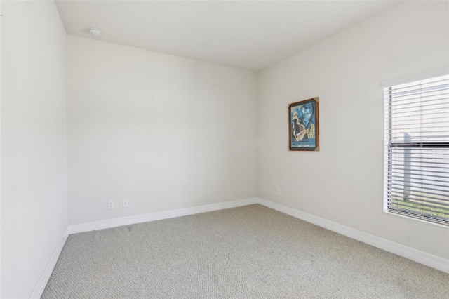 empty room with a healthy amount of sunlight, carpet, and baseboards