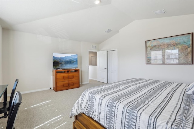 carpeted bedroom with lofted ceiling, a closet, visible vents, and baseboards