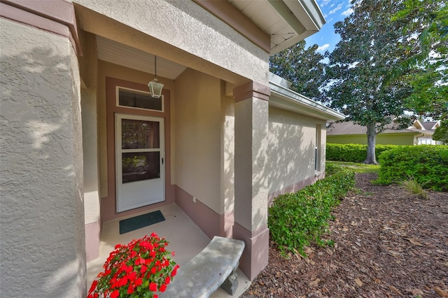 property entrance featuring stucco siding