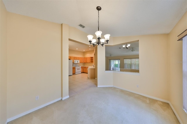 unfurnished room featuring light colored carpet, visible vents, a notable chandelier, and baseboards