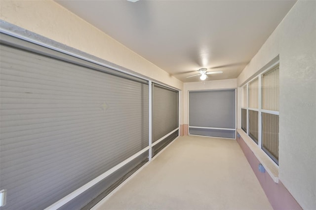 interior space with ceiling fan