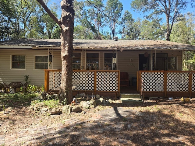 rear view of house featuring covered porch