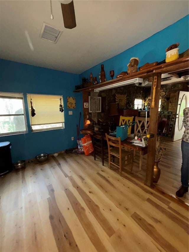 bedroom featuring a ceiling fan, wood finished floors, and visible vents