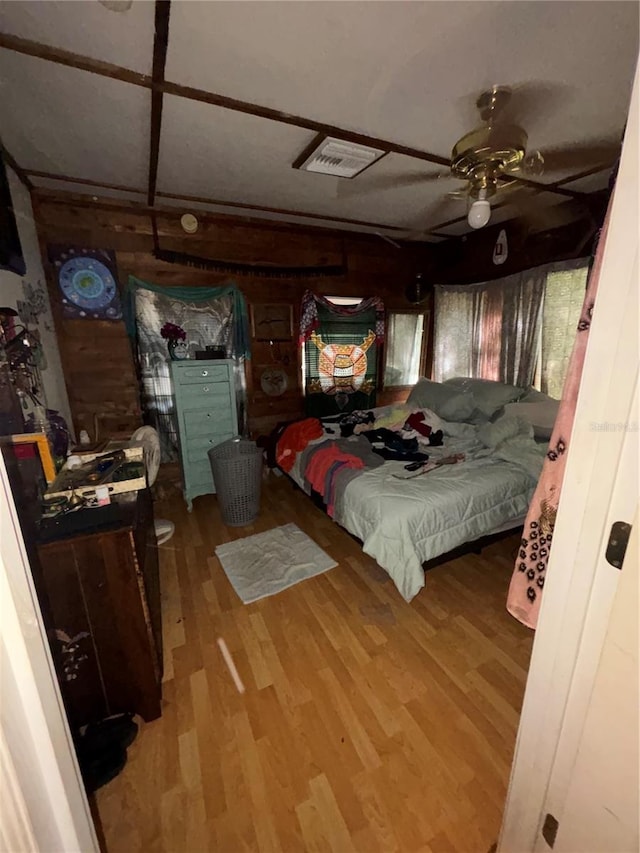 bedroom featuring wood finished floors and visible vents