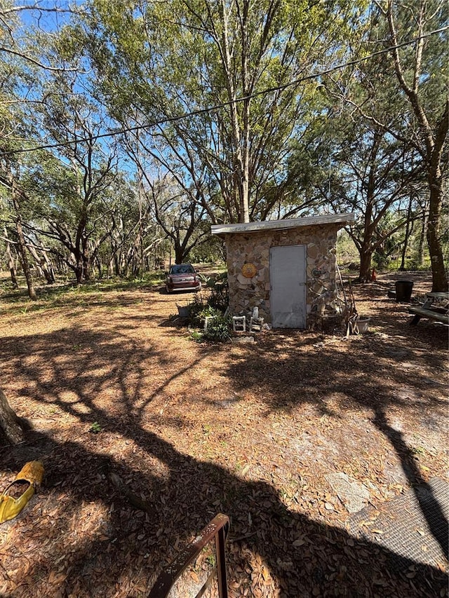 view of yard featuring an outbuilding and a shed