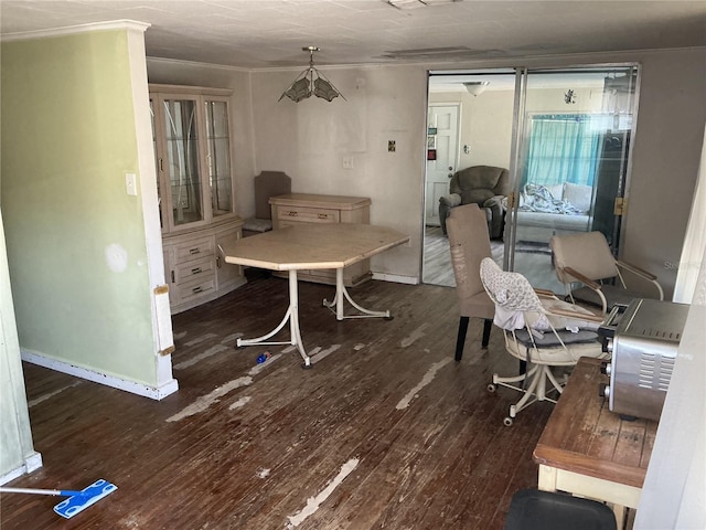 dining space featuring wood finished floors and baseboards