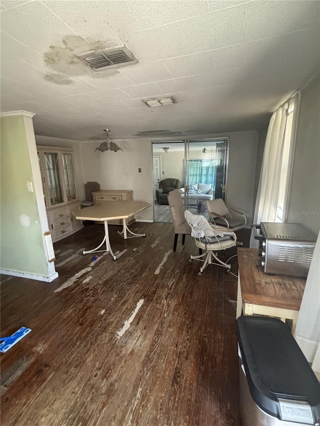 dining space with visible vents and wood finished floors