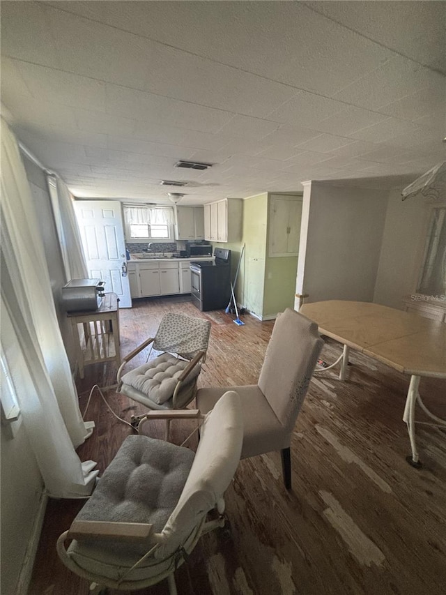 dining room with wood finished floors and visible vents