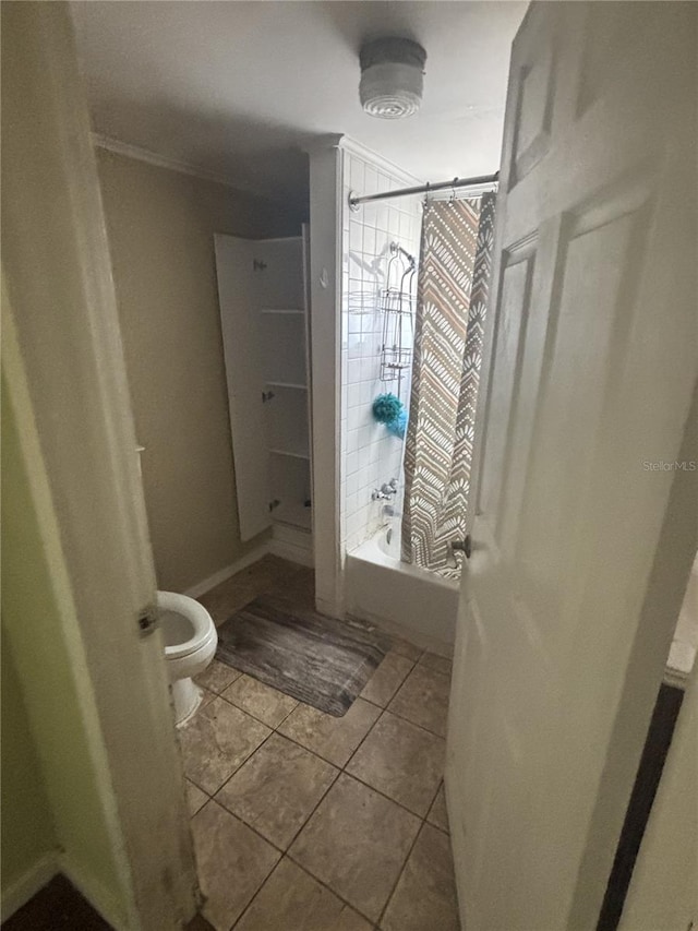 full bathroom with shower / tub combo with curtain, toilet, and tile patterned floors