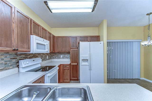 kitchen with brown cabinets, light tile patterned floors, tasteful backsplash, light countertops, and white appliances