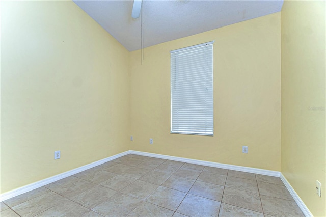 unfurnished room with tile patterned floors, a ceiling fan, and baseboards