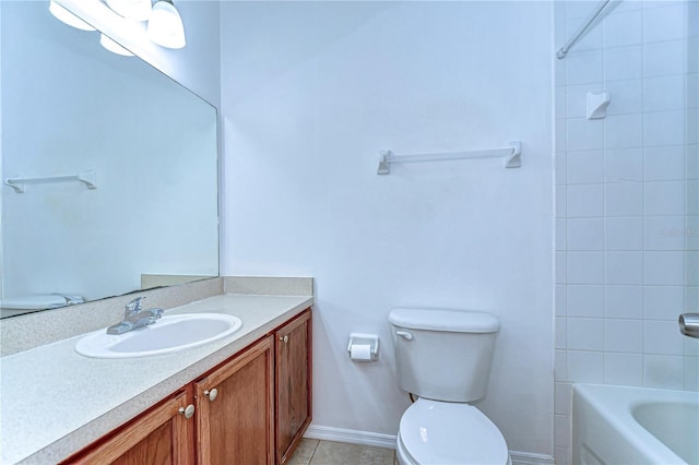 bathroom featuring toilet, tub / shower combination, vanity, tile patterned flooring, and baseboards