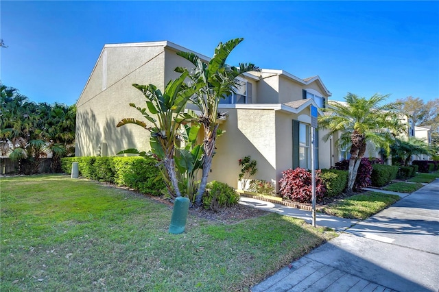 view of property exterior featuring a yard and stucco siding