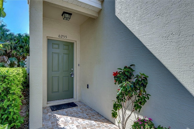 property entrance with stucco siding