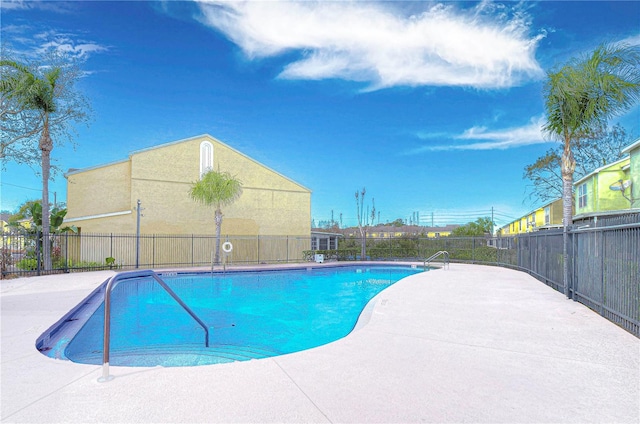 pool with fence and a patio