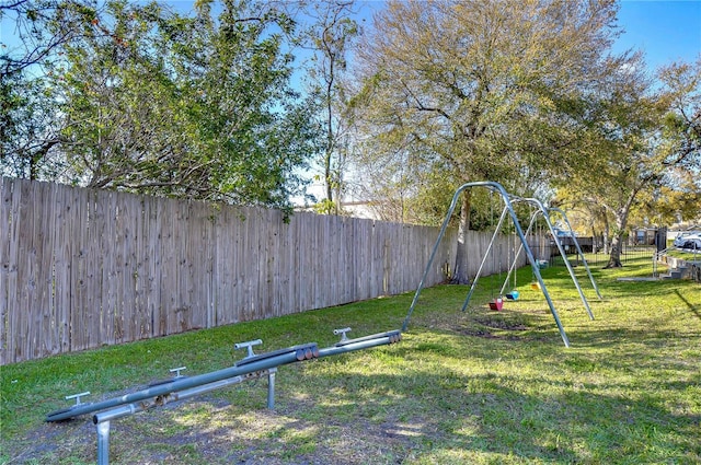 view of yard with a playground and fence