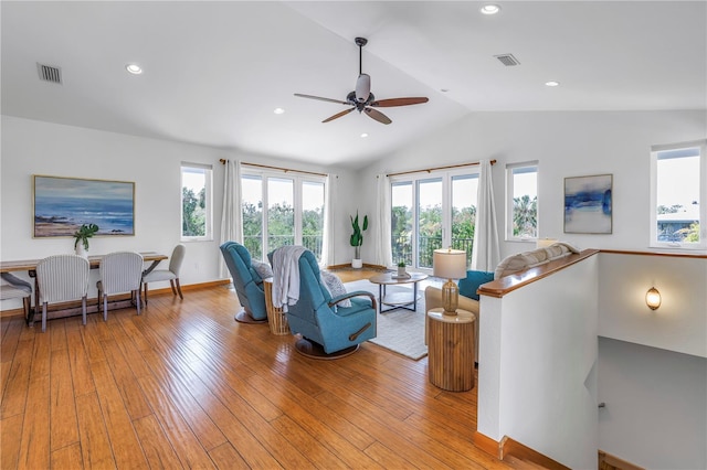 living area with lofted ceiling, light wood-style flooring, visible vents, and recessed lighting