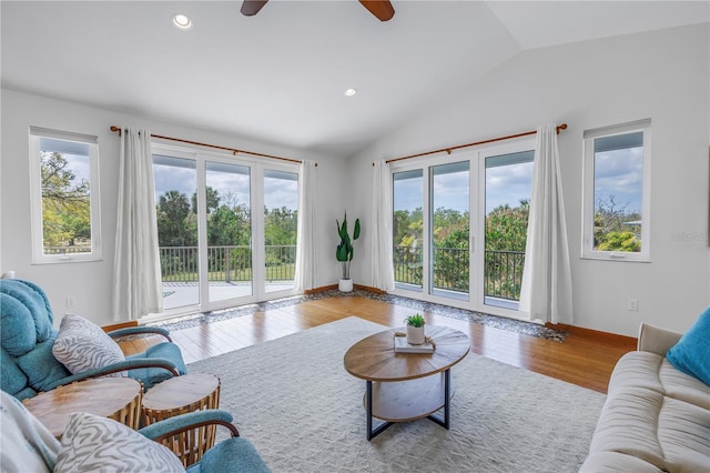 living area with vaulted ceiling, wood finished floors, a wealth of natural light, and recessed lighting