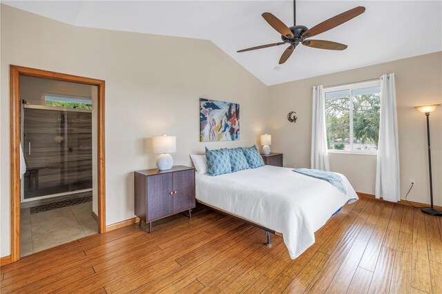 bedroom featuring light wood-style floors, ceiling fan, baseboards, and vaulted ceiling