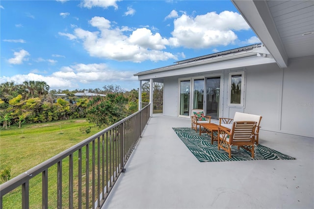 view of patio featuring a balcony