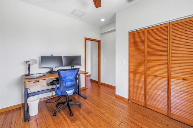 home office with recessed lighting, visible vents, baseboards, and hardwood / wood-style flooring