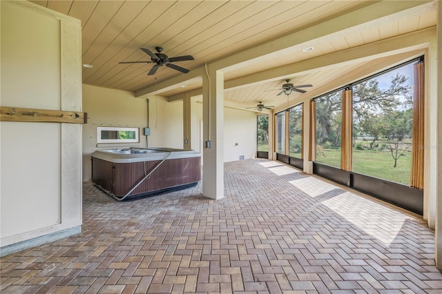 view of patio featuring a ceiling fan and a hot tub