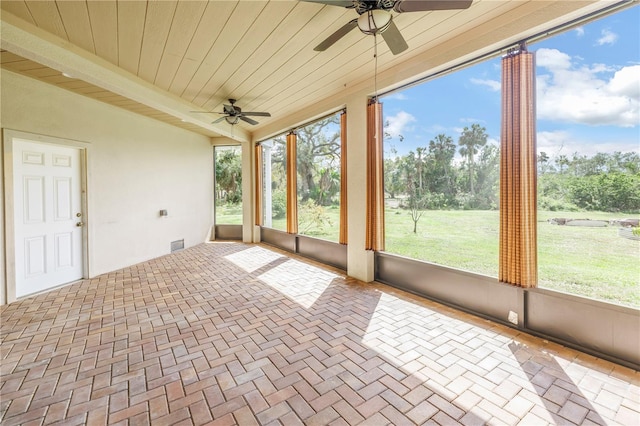 unfurnished sunroom with wooden ceiling and ceiling fan